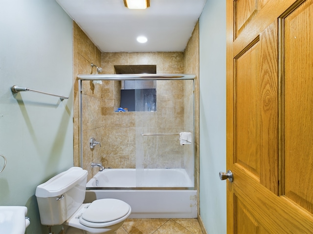 bathroom featuring shower / bath combination with glass door, toilet, and tile patterned floors