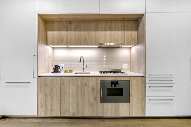 211 N Harbor Dr Unit 805, Chicago, IL 60601 - kitchen featuring light wood-type flooring, appliances with stainless steel finishes, white cabinetry, sink, and tasteful backsplash