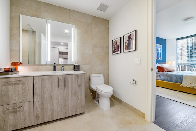 211 N Harbor Dr Unit 805, Chicago, IL 60601 - bathroom with tile walls, wood-type flooring, toilet, and vanity