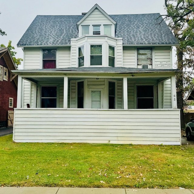 view of front of home with a porch and a front lawn