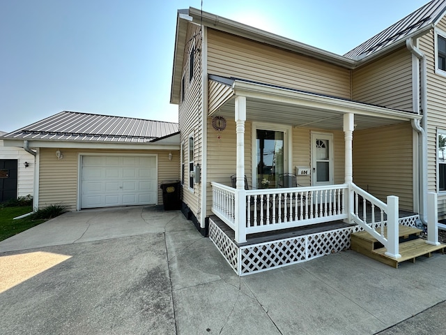 view of front facade featuring a porch and a garage