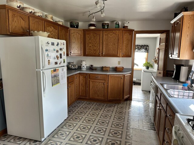 kitchen with stove, sink, and white fridge