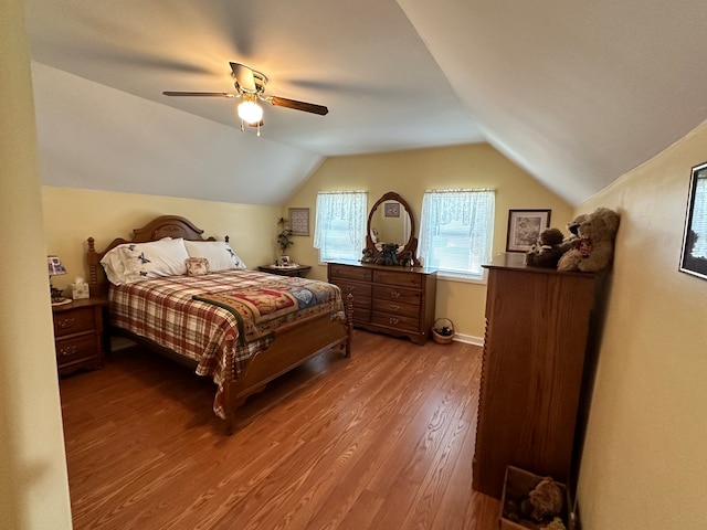 bedroom featuring lofted ceiling, ceiling fan, and hardwood / wood-style flooring