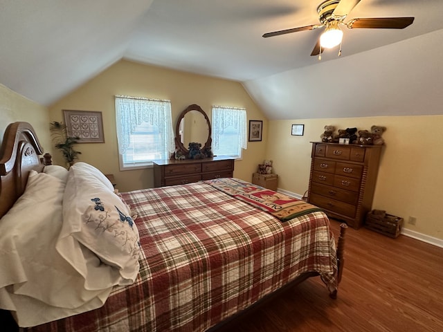 bedroom featuring ceiling fan, vaulted ceiling, and wood-type flooring