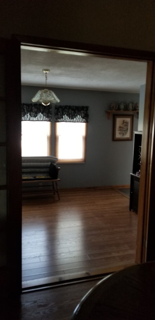 living room featuring a textured ceiling and dark hardwood / wood-style flooring