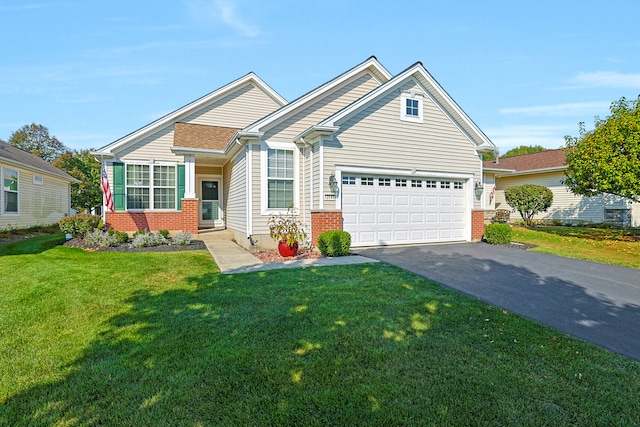 view of front of property with a front yard and a garage