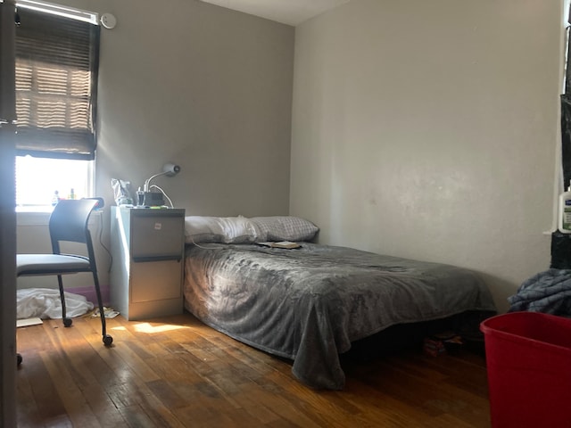 bedroom with hardwood / wood-style flooring