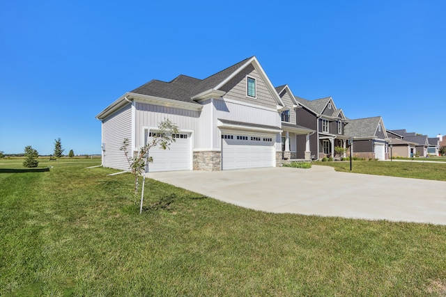 craftsman-style home featuring a garage and a front lawn