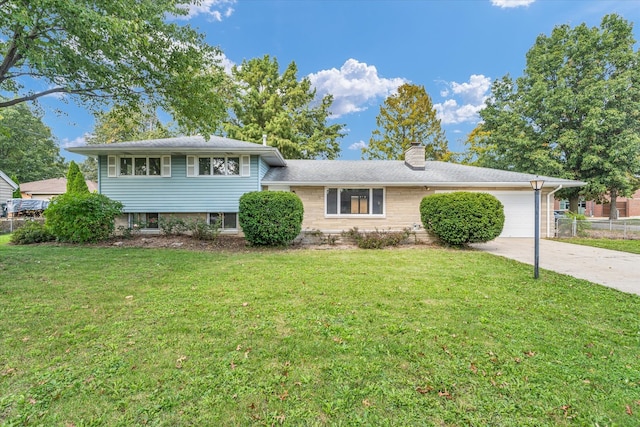 tri-level home with a garage and a front yard