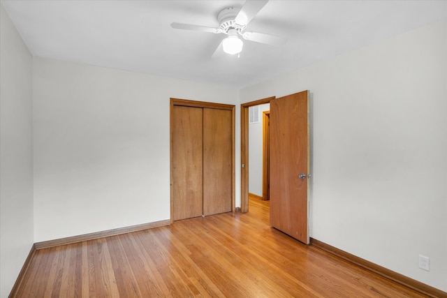 spare room with light wood-type flooring and ceiling fan