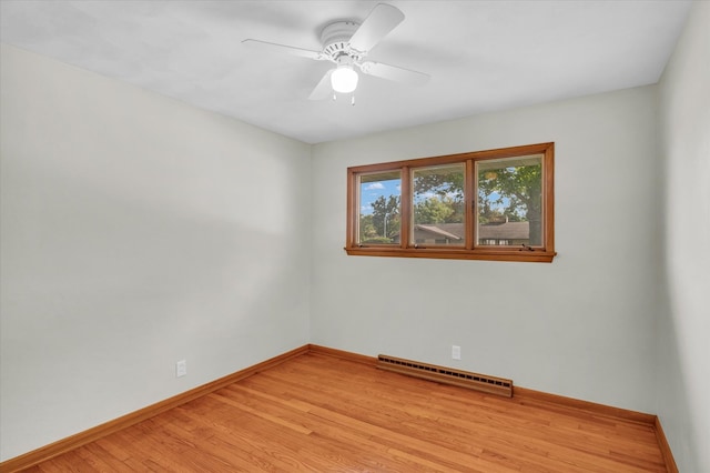 empty room with light wood-type flooring, ceiling fan, and a baseboard radiator