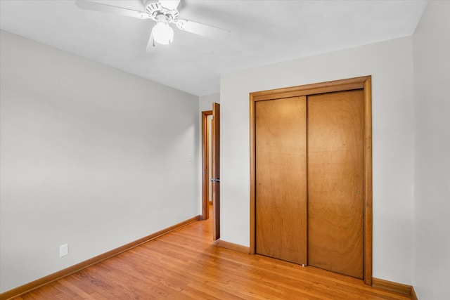 unfurnished bedroom featuring ceiling fan, a closet, and light hardwood / wood-style floors