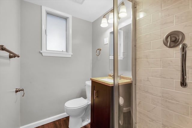 bathroom with vanity, a shower, hardwood / wood-style floors, and toilet