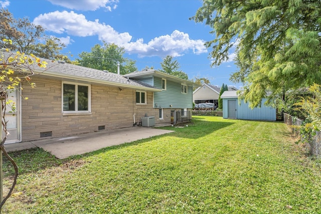 back of property featuring cooling unit, a yard, a storage unit, and a patio area