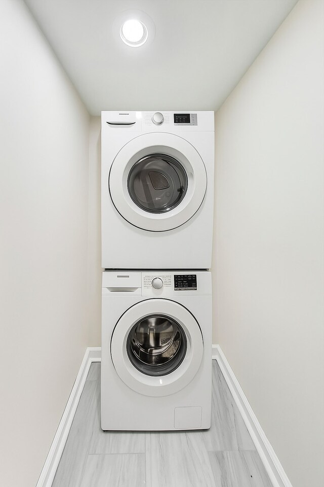 8251 S E End Ave, Chicago, IL 60617 - laundry area featuring estacked washer and dryer and baseboards