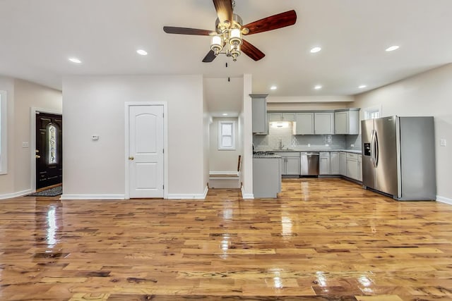 8251 S E End Ave, Chicago, IL 60617 - kitchen with stainless steel appliances, gray cabinets, light wood finished floors, a ceiling fan, and recessed lighting