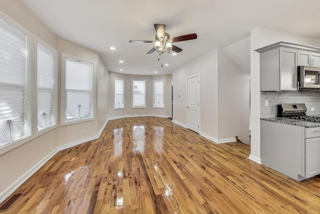 8251 S E End Ave, Chicago, IL 60617 - unfurnished living room featuring a ceiling fan, light wood-type flooring, and recessed lighting