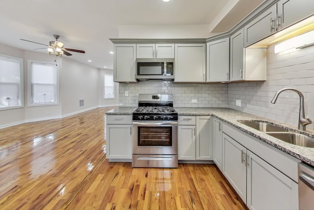 8251 S E End Ave, Chicago, IL 60617 - kitchen with stainless steel appliances, a ceiling fan, gray cabinetry, backsplash, and recessed lighting