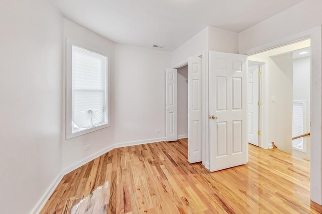 unfurnished bedroom featuring light wood-type flooring