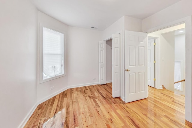 8251 S E End Ave, Chicago, IL 60617 - unfurnished bedroom with light wood finished floors and multiple windows