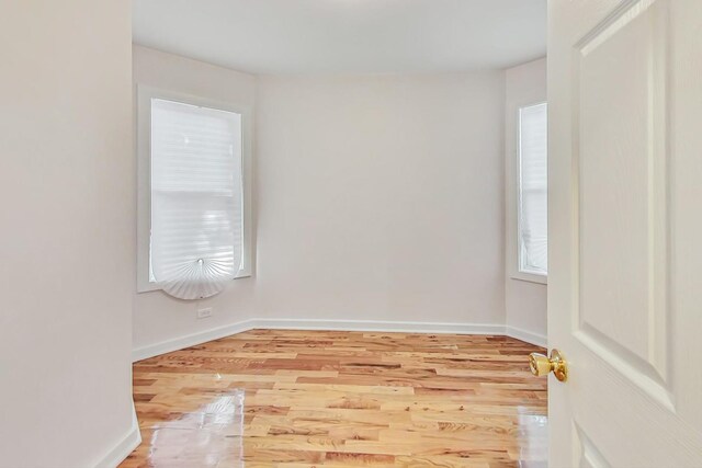 8251 S E End Ave, Chicago, IL 60617 - unfurnished bedroom featuring light wood-style floors and multiple windows