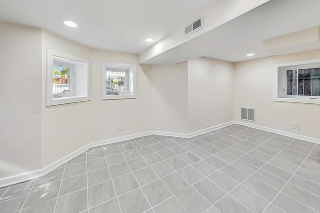 basement with light tile patterned flooring