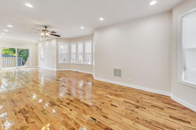 unfurnished living room featuring ceiling fan and light hardwood / wood-style floors