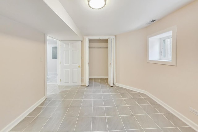 8251 S E End Ave, Chicago, IL 60617 - unfurnished bedroom with electric panel, a closet, and tile patterned floors