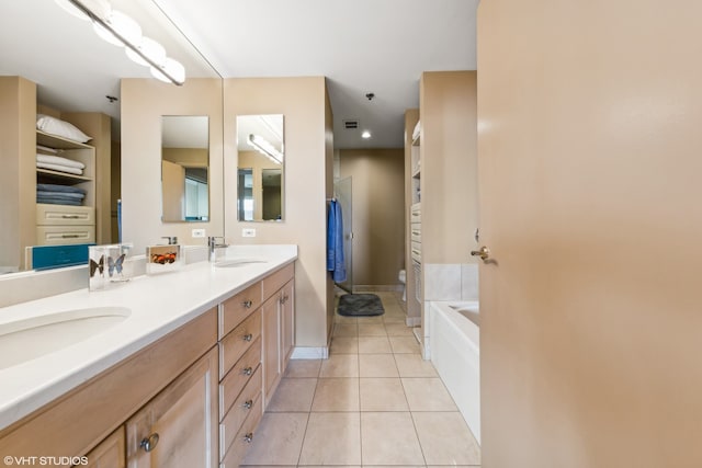 bathroom featuring vanity, tile patterned flooring, and a bathtub