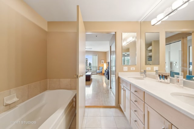 bathroom featuring vanity, hardwood / wood-style floors, and a washtub