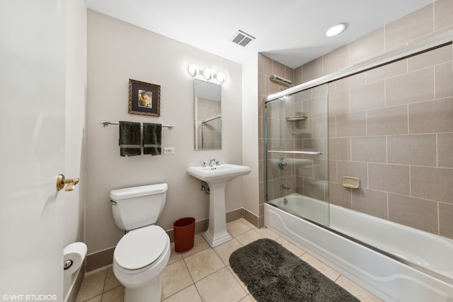 full bathroom featuring toilet, sink, tile patterned floors, and enclosed tub / shower combo