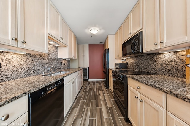 kitchen with black appliances, dark hardwood / wood-style flooring, sink, decorative backsplash, and stone countertops