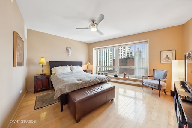 bedroom with light hardwood / wood-style flooring and ceiling fan