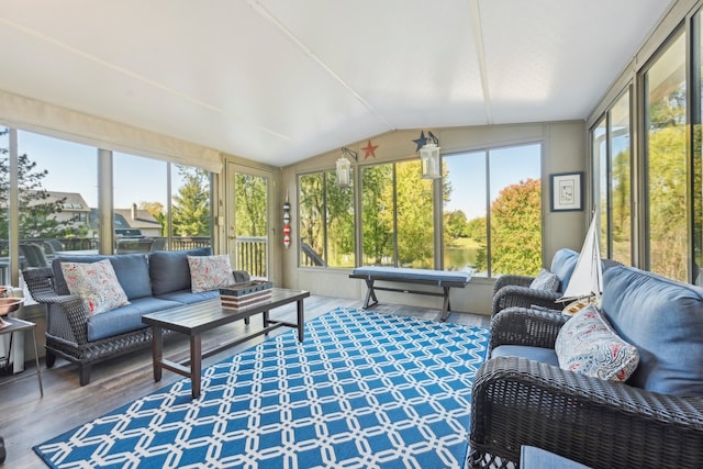 sunroom / solarium featuring vaulted ceiling and plenty of natural light