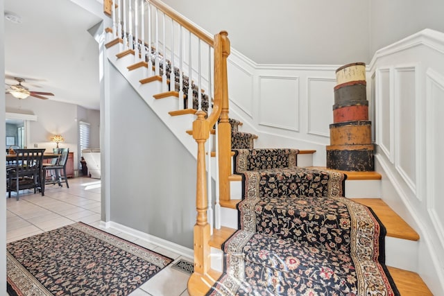 stairs with ceiling fan and tile patterned flooring