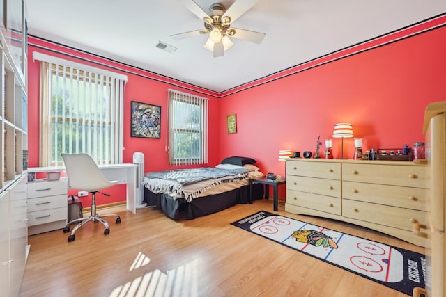 bedroom with hardwood / wood-style floors and ceiling fan