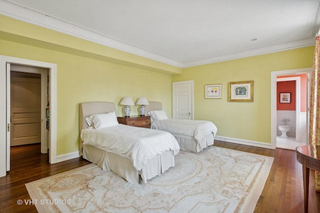 bedroom with crown molding, ensuite bathroom, and dark hardwood / wood-style flooring