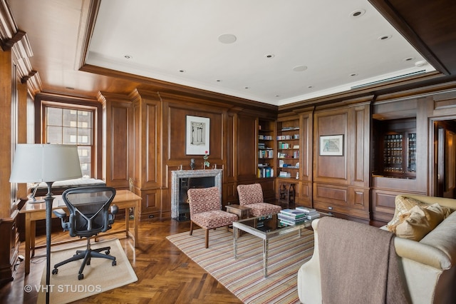 office area featuring a tray ceiling, dark parquet floors, and crown molding