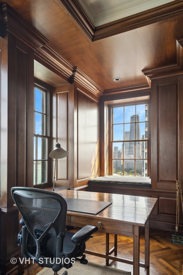 dining area with crown molding, wood walls, and plenty of natural light