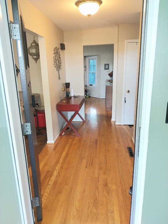 corridor featuring hardwood / wood-style floors