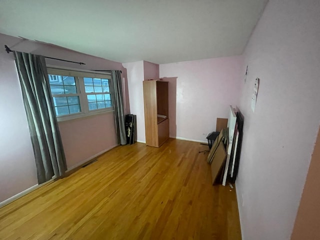 unfurnished bedroom with hardwood / wood-style floors