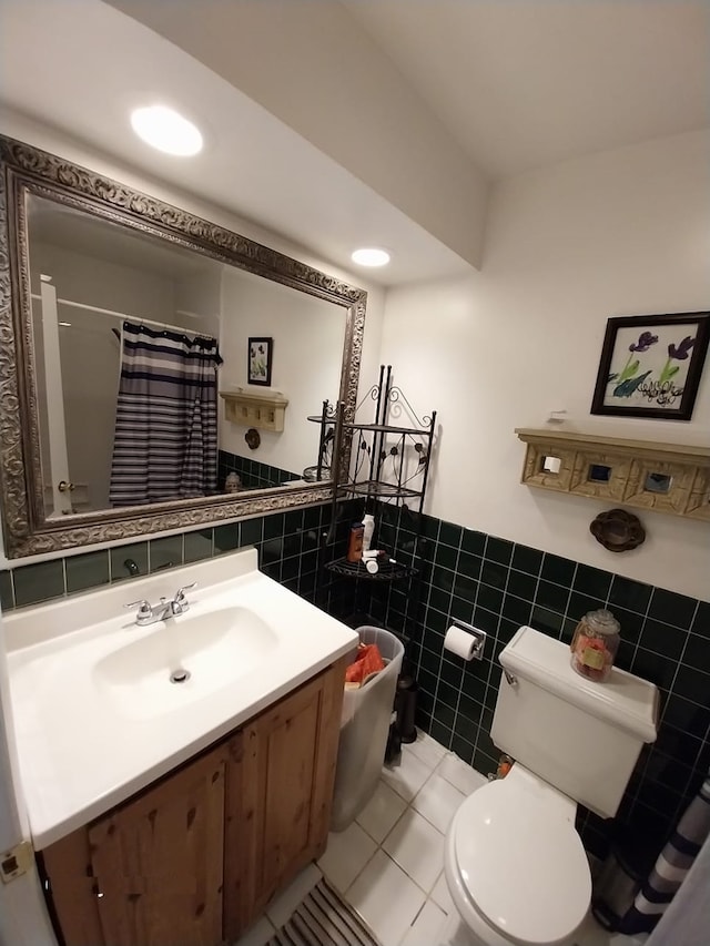 bathroom featuring a shower with shower curtain, tile patterned floors, toilet, tile walls, and vanity