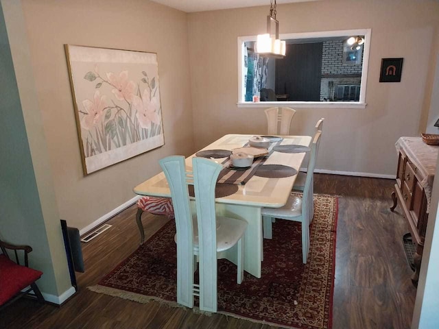 dining room with dark hardwood / wood-style flooring