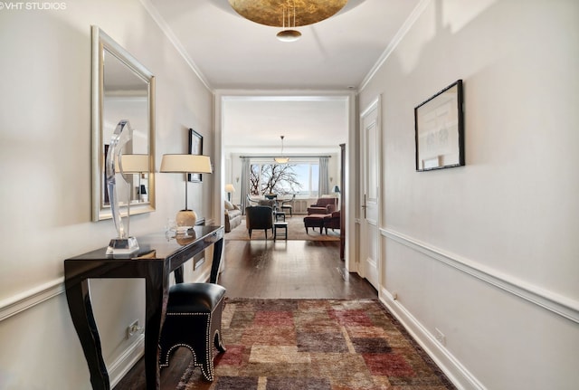 corridor with dark wood-type flooring and crown molding