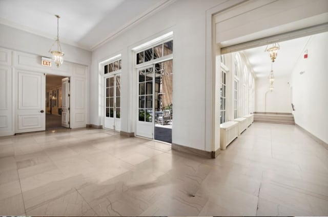 interior space with crown molding and an inviting chandelier