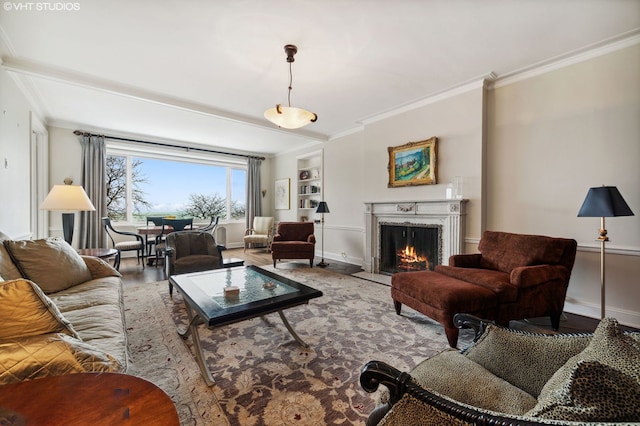 living room with built in shelves, wood-type flooring, and ornamental molding