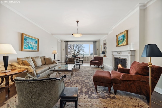 living room featuring hardwood / wood-style flooring, crown molding, and a premium fireplace