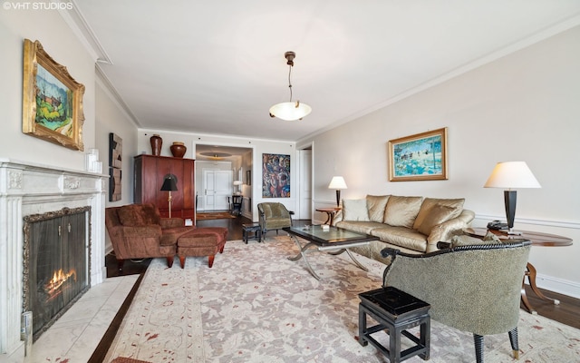 living room with a fireplace, crown molding, and light hardwood / wood-style flooring