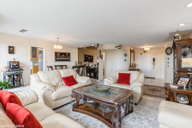 living room featuring a notable chandelier and light tile patterned floors