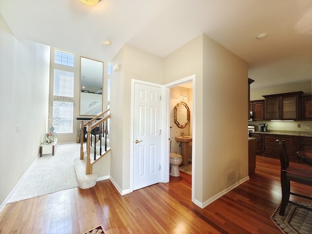 hallway with hardwood / wood-style flooring